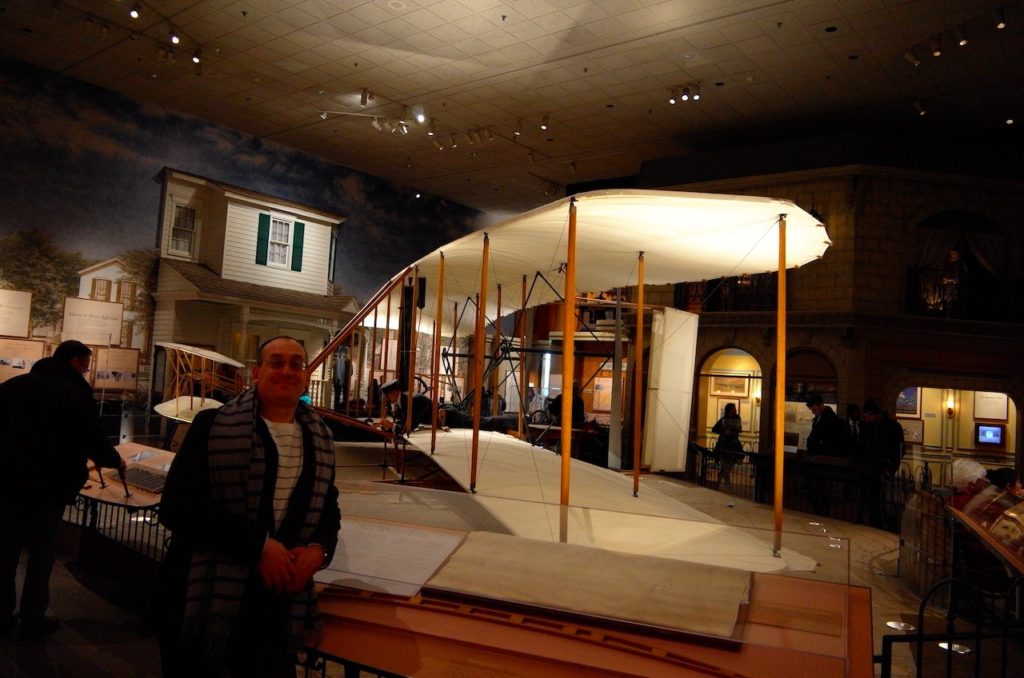 Michael standing in front of the Wright Flyer.