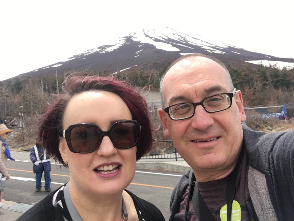 Mardi and I in front of Mouth Fuji. The mountain is covered in snow near its peak.