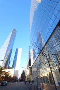 Image of the WTC. Blue sky, blue glass building. It’s really tall The WTC is reflected in an adjacent building