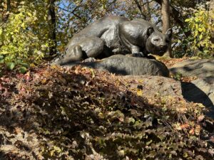 Still hunt. Statue of a panther on a rocky outcrop