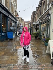 Mardi in a rain jacket standing on the middle of flask lane in Hampstead
