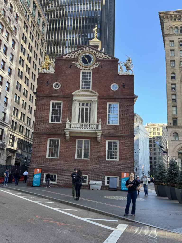 The old state house. Boston’s oldest building and site of the Boston massacre. Red brick, 3cstories high. Clock on the top centre an ornate lion on one side and unicorn on the other sit atop the buikding