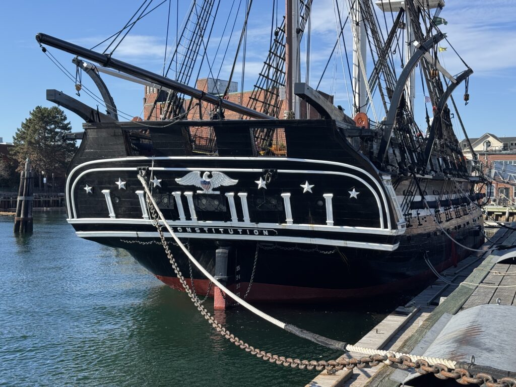 The read of the USA vondtitution. A ship. It’s black and white wooden frame can be seen.