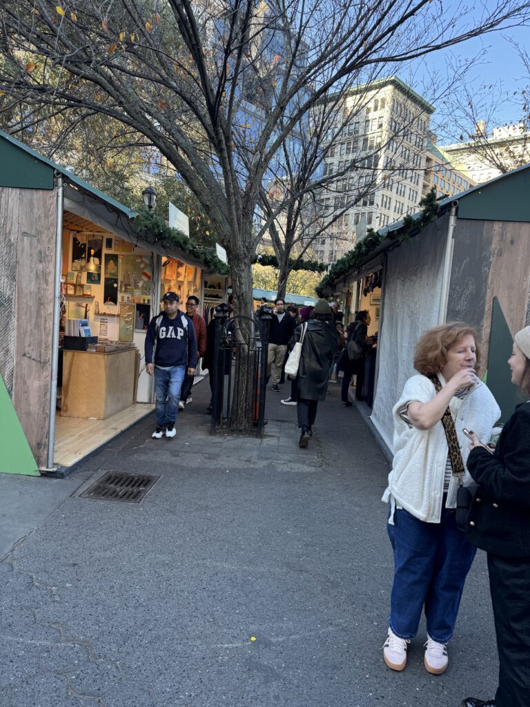 Union square markets, image of Stella on left and right, people milling about 