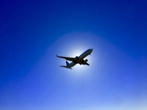 aircraft flying with the sun behind it